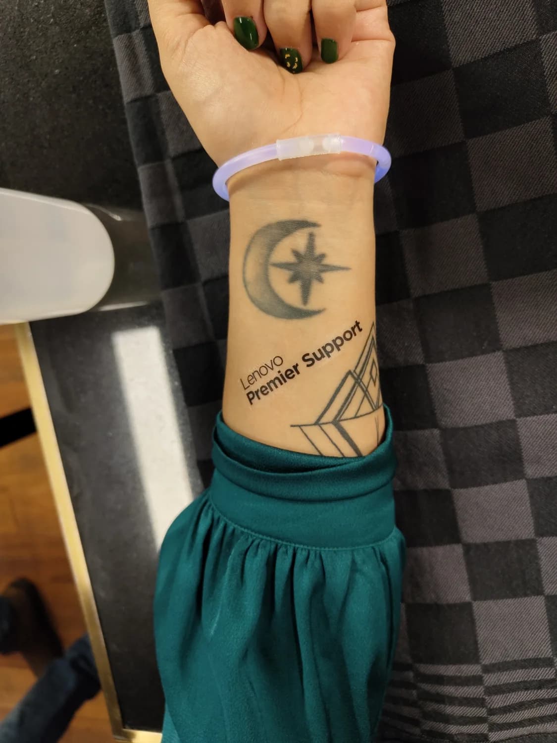 Lenovo Premier Support branded tattoo with celestial motif on a wrist