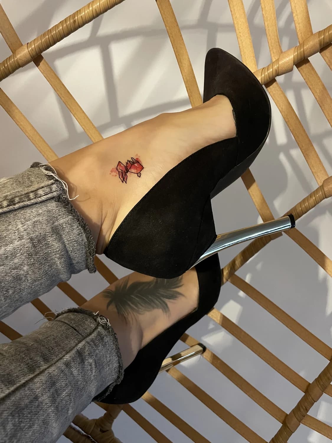 Small geometric fox on an ankle above heels