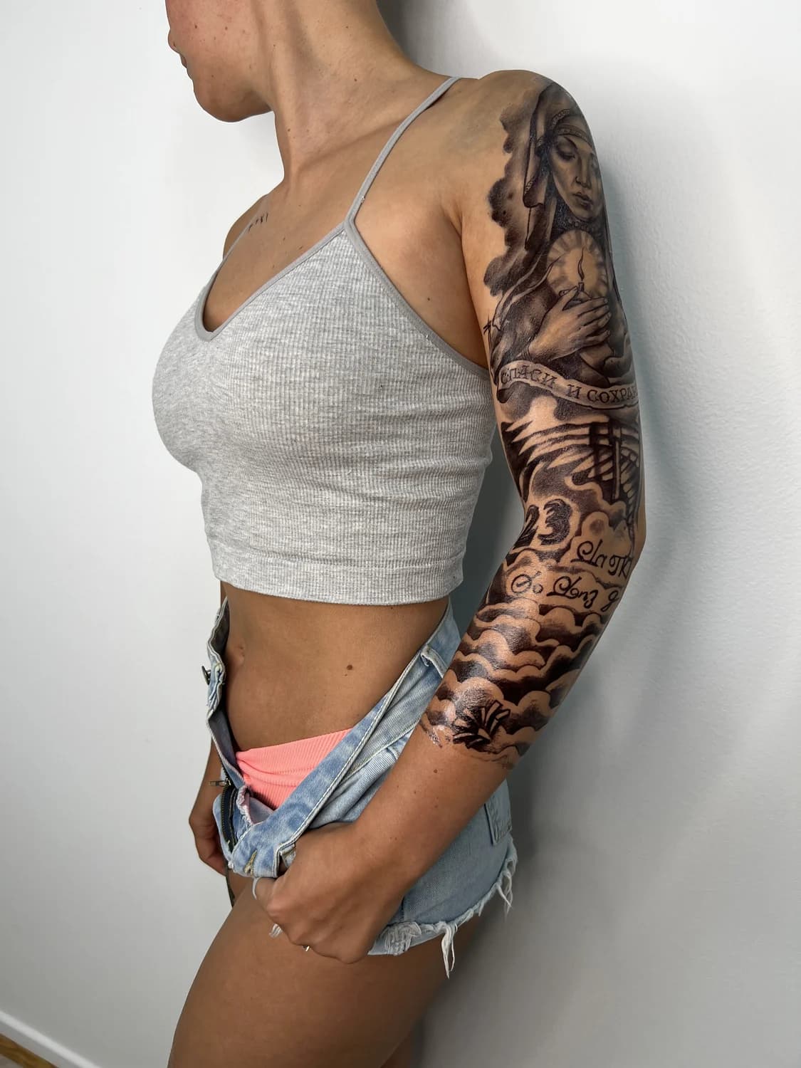 Black-and-grey realism full sleeve worn with a grey crop top