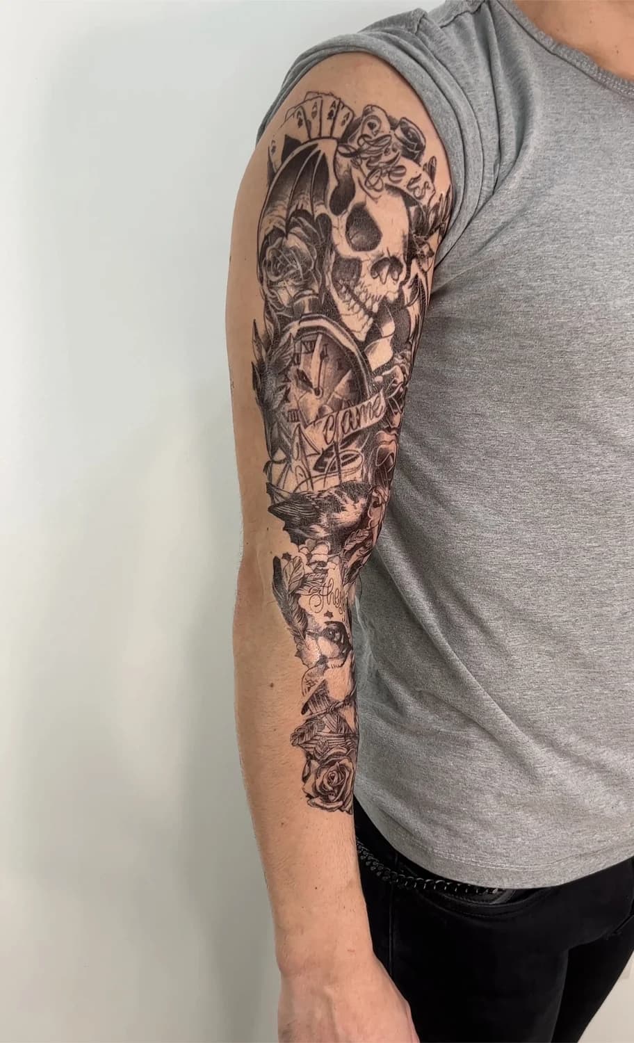 Skull-and-roses full sleeve in black-and-grey realism