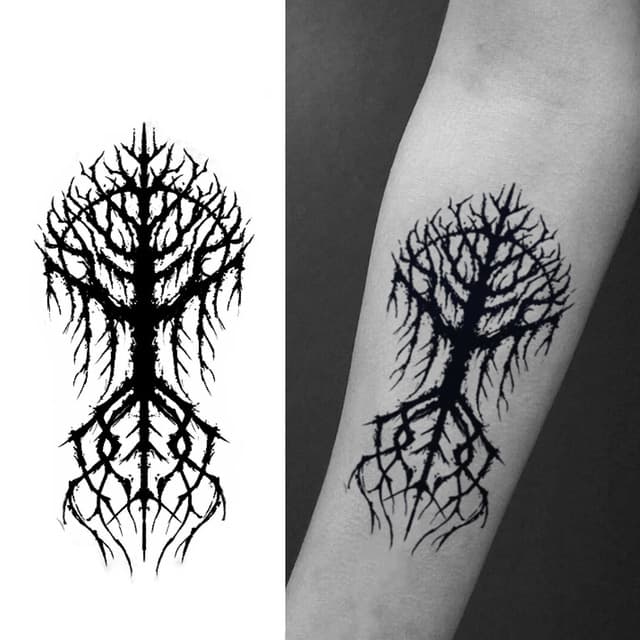 Blackened tree of life with bared roots