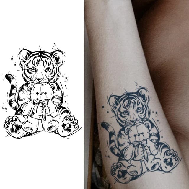 Tiger cub with teddy — view 1